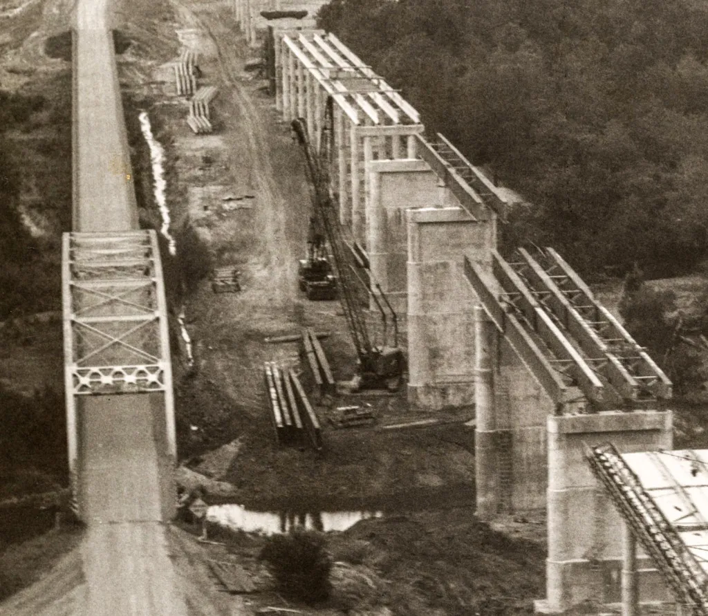 The old and the new.  The old truss bridge which crossed the Sabine River for three decades stands next to the support structures which are being constructed as part of the new Pendleton Bridge which will cross Toledo Bend lake