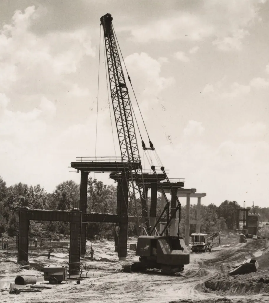 Bridge beams being lowered into place by heavy cranes