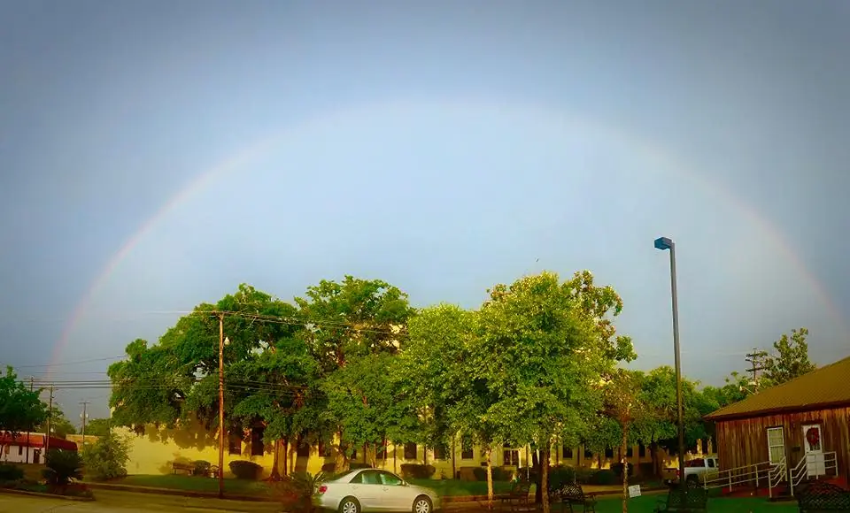 Photograph from the Facebook post “Taken a few minutes ago, with the rainbow wrapped around the Sabine Courthouse”
