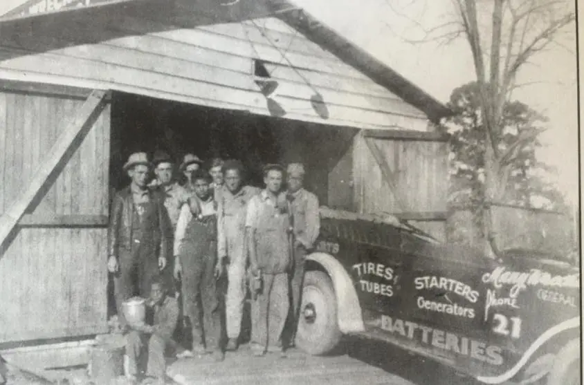 Photograph from the Facebook post “The crew members who worked for Reuben Peterson at the Many Wrecking Yard pose in this…”