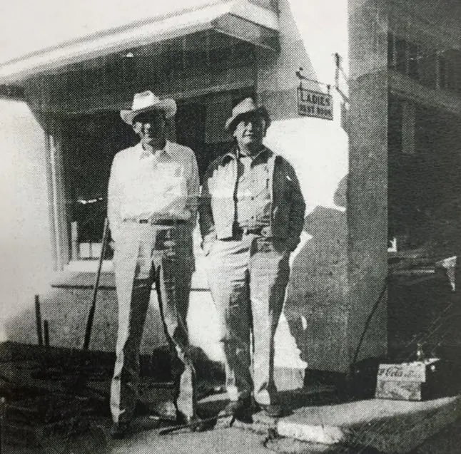 Photograph from the Facebook post “Sheriff George Cook with Ray Alford in front of Levi Remedies Service Station in Many.”