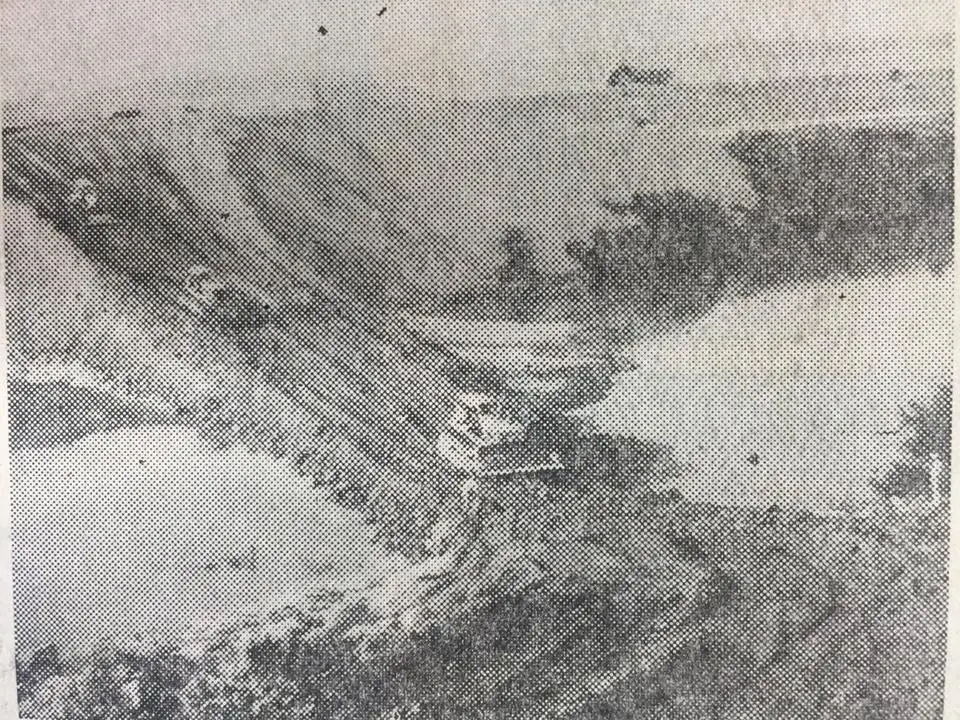 Photograph from the Facebook post “A dozer pushes dirt into the Sabine River, making the coffer dam reach from bank to bank.”