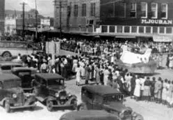 Photograph from the Facebook post “A crowd gathered to watch the parade at the intersection of First Street and Washington…”