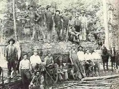 Photograph from the Facebook post “Timber workers posed on a large log.”