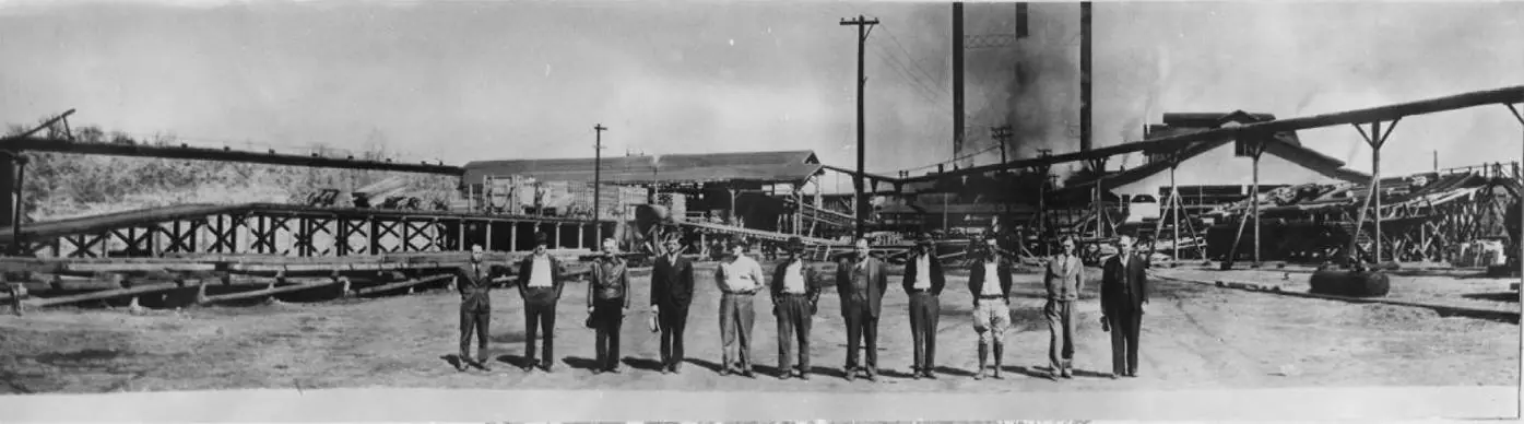 Photograph from the Facebook post “Photograph of eleven men standing in front of the Deweyville, Texas Sawmill.”