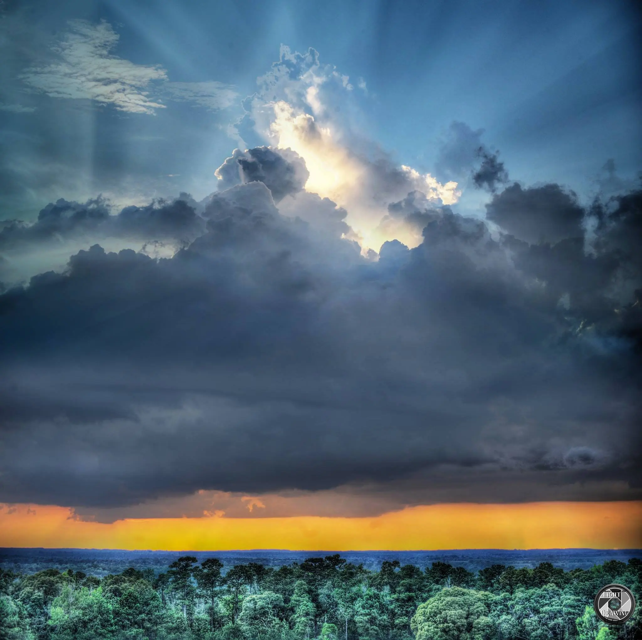 Photograph from the Facebook post “Sun rays breaking through the clouds, looking towards Texas from Hodges Gardens in…”